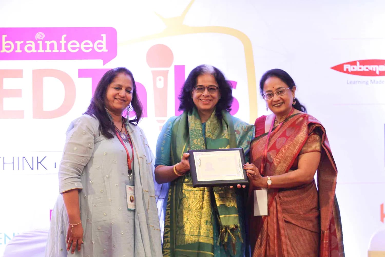 Ritu Vaish receiving a certificate on stage at Brainfeed EDTalks