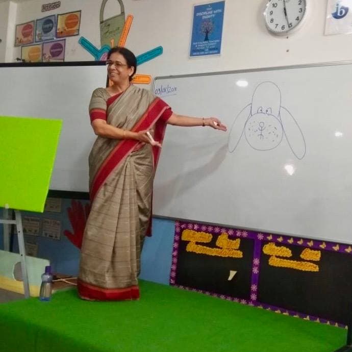 Ritu drawing on a whiteboard during the workshop