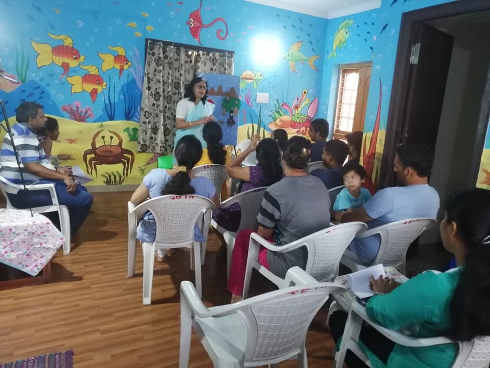 Parents seated and listening at the session