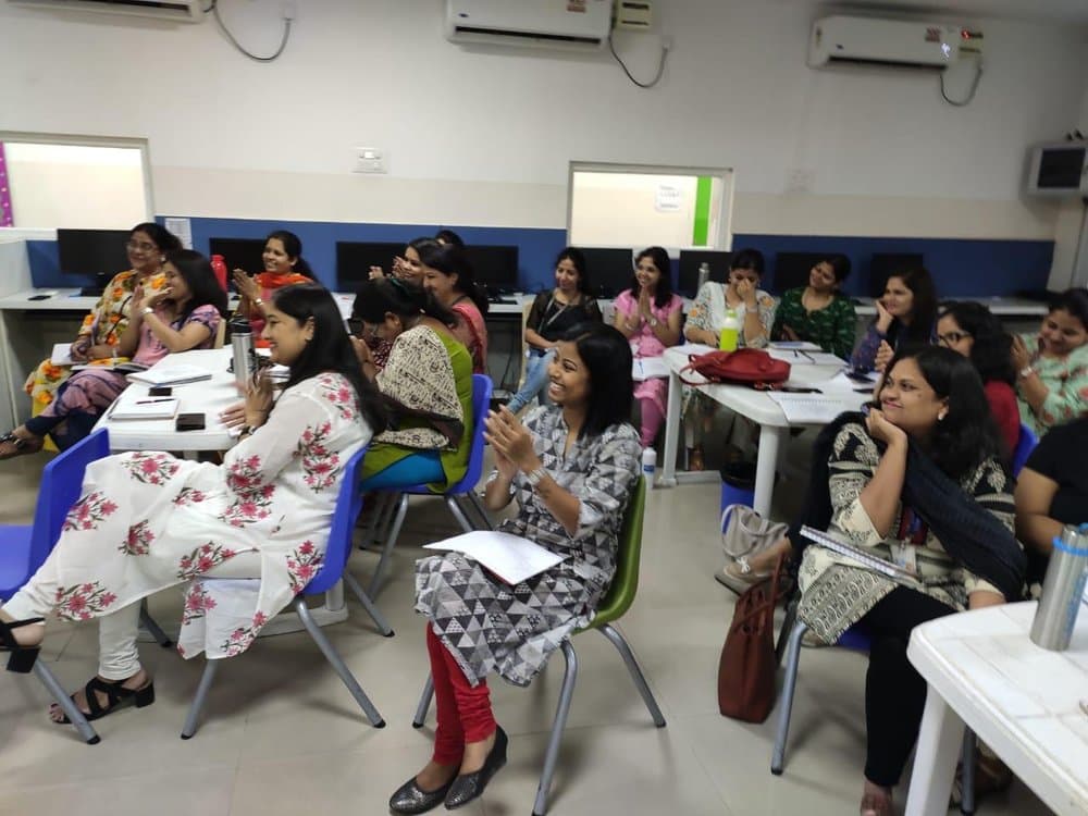 Teachers seated at desks during the session